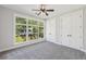 Bright bedroom with neutral carpet, large window, and double-door closet at 1140 Hubbard Sw St, Atlanta, GA 30310