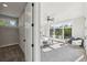 Bright bedroom featuring a ceiling fan, large windows, and a spacious walk-in closet with shelving at 1140 Hubbard Sw St, Atlanta, GA 30310