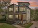 Modern two-story home featuring large windows, stone accents, inviting porch, and manicured lawn at 1140 Hubbard Sw St, Atlanta, GA 30310