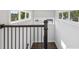 Hallway with wood flooring, a dark banister, and multiple windows at 1140 Hubbard Sw St, Atlanta, GA 30310