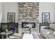 Comfortable living room with a stone fireplace and tasteful decor, creating a relaxing and stylish living space at 1140 Hubbard Sw St, Atlanta, GA 30310