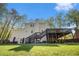 Backyard view of the two-story home with a deck and lush green lawn at 1931 Mceachern Manor Sw Dr, Marietta, GA 30064