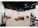 Finished basement with carpet, white walls, black ceiling and a sitting area with instruments at 1931 Mceachern Manor Sw Dr, Marietta, GA 30064