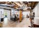 Unfinished basement with exposed pipes, wood beams, and a side entrance to the backyard at 1931 Mceachern Manor Sw Dr, Marietta, GA 30064