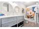 Bathroom with double sinks, modern mirrors, updated cabinets, and a colorful shower curtain at 1931 Mceachern Manor Sw Dr, Marietta, GA 30064