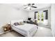 Bright bedroom featuring a ceiling fan, a large window with nature view, and a study desk at 1931 Mceachern Manor Sw Dr, Marietta, GA 30064