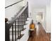 Elegant entryway with hardwood floors and a staircase with wrought iron spindles at 1931 Mceachern Manor Sw Dr, Marietta, GA 30064
