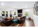 Bright living room with fireplace, mounted TV, comfortable seating, and outdoor access at 1931 Mceachern Manor Sw Dr, Marietta, GA 30064