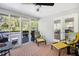 Cozy screened-in porch featuring outdoor seating, ceiling fan, and wooded views, perfect for relaxing at 1931 Mceachern Manor Sw Dr, Marietta, GA 30064