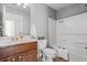 Bathroom featuring a vanity, a toilet, and a bathtub/shower combo with a white curtain at 206 Cole Ct, Canton, GA 30114