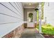 Inviting front porch featuring a decorative wreath, stone accents, and tidy landscaping at 206 Cole Ct, Canton, GA 30114