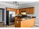Cozy kitchen with wood cabinets, stainless appliances, and ample counter space at 206 Cole Ct, Canton, GA 30114