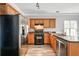 Modern kitchen boasts stainless steel appliances, wooden cabinets, and sleek countertops at 206 Cole Ct, Canton, GA 30114