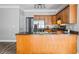 Well-lit kitchen features wood cabinets, stainless steel appliances, and ample counter space at 206 Cole Ct, Canton, GA 30114