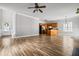 Open-concept living space with hardwood floors, blending the living room, kitchen, and dining area at 206 Cole Ct, Canton, GA 30114