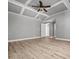 Large main bedroom with tray ceiling, ceiling fan, and light wood-look flooring at 206 Cole Ct, Canton, GA 30114