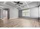 Bright main bedroom featuring tray ceiling, ceiling fan, and large windows for natural light at 206 Cole Ct, Canton, GA 30114