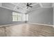 Spacious main bedroom featuring tray ceilings, large windows, and wood-look flooring at 206 Cole Ct, Canton, GA 30114