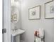 This powder room has a decorative mirror, open vanity and framed art at 2424 Lakeshore Se Ln, Atlanta, GA 30316