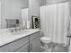Neutral bathroom featuring a white shower curtain, marble floors, and modern sink at 2424 Lakeshore Se Ln, Atlanta, GA 30316