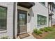 Charming front door with a 'Welcome' mat, painted brick, and modern exterior light fixture at 2424 Lakeshore Se Ln, Atlanta, GA 30316