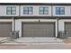 Townhome garage doors with gray paint and white facade at 2424 Lakeshore Se Ln, Atlanta, GA 30316