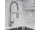 Modern kitchen sink features a spring faucet and white marble-look backsplash at 2424 Lakeshore Se Ln, Atlanta, GA 30316