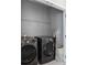 Laundry room featuring gray washer and dryer with metal shelving and gray walls at 2424 Lakeshore Se Ln, Atlanta, GA 30316