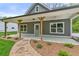Close up of a craftsman-style home with a covered porch and beautifully landscaped front yard at 5232 W Mountain St, Stone Mountain, GA 30083