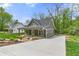 View of a beautifully landscaped home with a modern driveway and craftsman-style architecture at 5232 W Mountain St, Stone Mountain, GA 30083