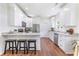 Bright, open kitchen with white cabinets, granite countertops, and stainless steel appliances at 5232 W Mountain St, Stone Mountain, GA 30083