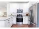 Modern kitchen with stainless steel appliances, granite countertops, and bright white cabinetry at 5232 W Mountain St, Stone Mountain, GA 30083