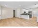 Open-concept kitchen featuring stainless appliances, granite countertops and hardwood flooring throughout at 5232 W Mountain St, Stone Mountain, GA 30083