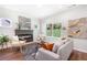 Comfortable living room featuring neutral furniture, a fireplace, and large windows for natural light at 5232 W Mountain St, Stone Mountain, GA 30083