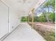 Covered porch with wood columns and a concrete floor overlooking a spacious yard at 5232 W Mountain St, Stone Mountain, GA 30083