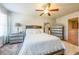 Comfortable bedroom featuring a ceiling fan, a chest of drawers, and carpeted flooring at 7144 Gladstone Cir, Stonecrest, GA 30038