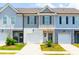 Charming townhomes featuring attached garages and manicured lawns enhance curb appeal at 7144 Gladstone Cir, Stonecrest, GA 30038