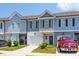 Attractive townhomes with garages, well-kept lawns, and colorful landscaping create a welcoming exterior at 7144 Gladstone Cir, Stonecrest, GA 30038