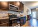 Well-lit kitchen with stainless steel oven, granite countertops, and convenient access to the door and hallway at 7144 Gladstone Cir, Stonecrest, GA 30038