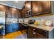 Modern kitchen featuring granite countertops, stainless steel appliances, and elegant dark wood cabinetry at 7144 Gladstone Cir, Stonecrest, GA 30038