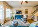 Comfortable living room showcasing bright windows, wood floors, and a blue accent cabinet at 7144 Gladstone Cir, Stonecrest, GA 30038