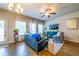 Cozy living room with hardwood floors, a ceiling fan, and plenty of natural light at 7144 Gladstone Cir, Stonecrest, GA 30038