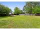 Sprawling backyard featuring a fire pit area, mature trees, and plenty of space for outdoor activities at 2529 Ridgecrest Nw Dr, Kennesaw, GA 30152