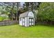 Charming backyard storage shed with double doors, providing ample storage for outdoor equipment at 2529 Ridgecrest Nw Dr, Kennesaw, GA 30152
