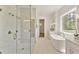 Modern bathroom featuring a glass shower, soaking tub, and marble tile at 4059 Yellow Creek Trl, Cumming, GA 30028