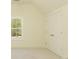 Neutral toned bedroom offering a bright window and convenient closet space at 4059 Yellow Creek Trl, Cumming, GA 30028