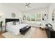 Spacious bedroom with natural light, decorative lighting, and sleek, contemporary furnishings at 4059 Yellow Creek Trl, Cumming, GA 30028