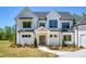 Charming two-story home boasts a welcoming entrance and beautifully landscaped front yard at 4059 Yellow Creek Trl, Cumming, GA 30028