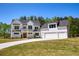 Stunning two-story modern farmhouse featuring a three-car garage and manicured lawn at 4059 Yellow Creek Trl, Cumming, GA 30028