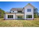 The home's rear exterior with large windows offers great backyard views from multiple rooms at 4059 Yellow Creek Trl, Cumming, GA 30028